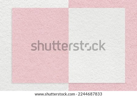 Texture of white and pink paper background with geometric shape and pattern, macro. Structure of craft rose cardboard with frame. Felt abstract backdrop closeup.