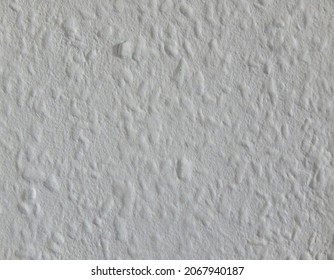 Texture of a white rough wallpaper, background with copy space