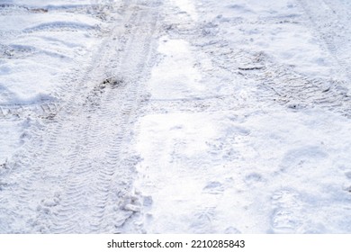 Texture Of White Winter Country Road, Tire Tracks And Shoe Prints In Snow