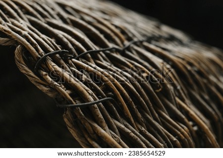 Texture of wicker basket on a dark background. Close-up. Selective focus.
