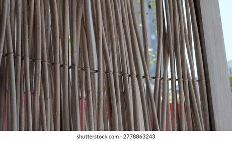 Texture wicker fence, a decorative fence, a wattle fence, branches, lath fence