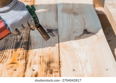 The texture of wood treated with fire using a burner. The process of burning wooden boards. Close-up.