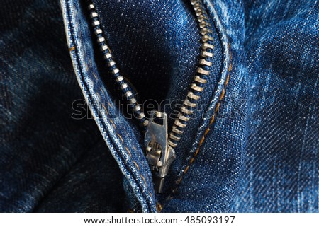 texture of worn blue jeans with zipper
