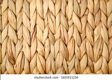 Texture of woven beige straw, background of braids from the plant stem close-up - Powered by Shutterstock