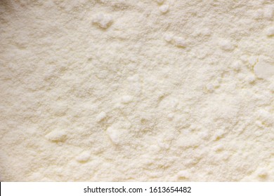 Texture Of Yellow Dry Baby Food, Milk Powder. Close-up, Macro 