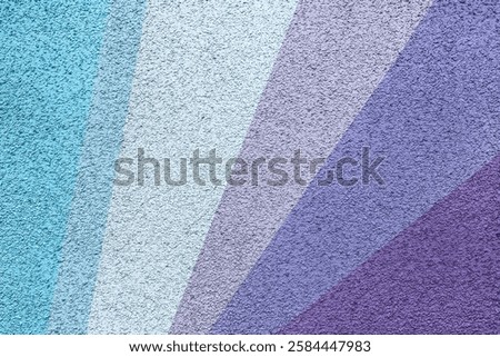 A textured abstract background featuring diagonal color stripes in shades of blue, lavender, and purple with a rough surface finish, creating a vibrant and artistic visual.