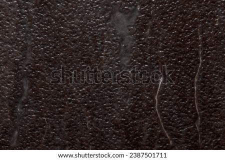 Textured background image resembling divoted or dimbled brown stone with marbling streaks.