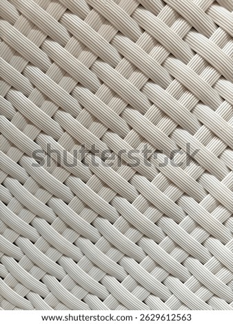 Textured background made of plastic that is carefully weaven and forms a comfortable chair