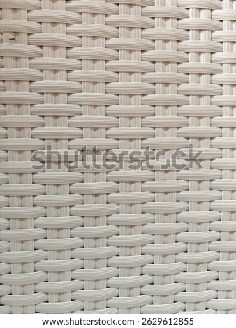 Textured background made of plastic that is carefully weaven and forms a comfortable chair