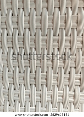 Textured background made of plastic that is carefully weaven and forms a comfortable chair