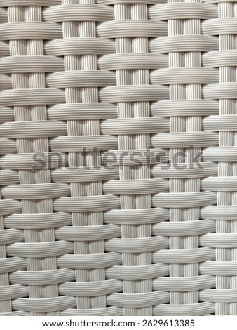 Textured background made of plastic that is carefully weaven and forms a comfortable chair