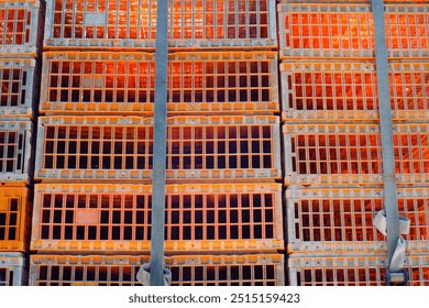 Textured Background of a stack of chicken stock storage boxes for delivery. Orange storage boxes on a truck. Food Industry. Livestock industry. Detail and texture. Wallpaper Backgrounds Photography