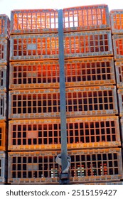 Textured Background of a stack of chicken stock storage boxes for delivery. Orange storage boxes on a truck. Food Industry. Livestock industry. Detail and texture. Wallpaper Backgrounds Photography