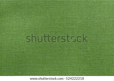 the textured background or wallpaper from rough fabric of green lime color and a blank space