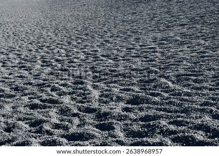 Textured Beach Sand Patterns in Low Light - Natural Coastal Landscape
