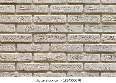 Textured beige brick wall, stone texture. decorative tiles for wall decoration. Background,  beige decorative brick. loft decor style. structural surface, imitates old brick