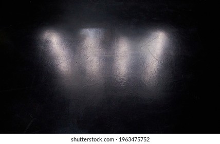 Textured black background with light hitting the Shiney surface 