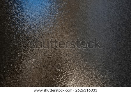 Textured black metallic surface with subtle reflective highlights and uniform pebble-like granularity. The smooth yet rough appearance is excellent for industrial design, sci-fi textures