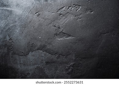 Textured black surface with subtle patterns in natural light