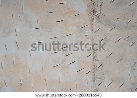 Textured concrete surface with linear indentations and weathered appearance