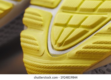 Textured Design Of The Sole Of The Tread Of A Sneaker In Yellow Macro. Close-up