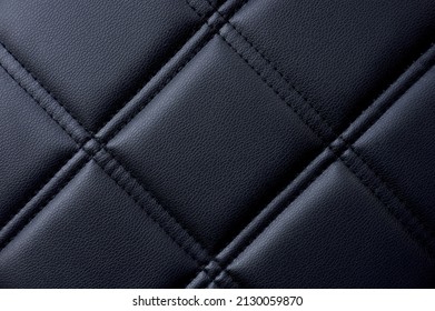 textured detail of black capitone with diamonds or checks