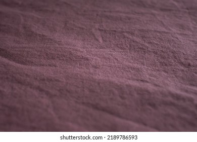 Textured fabric in the color of a dusty rose. Fabric background. Crumpled bed. Cotton texture. Calico bed sheet. Pink material. Home comfort. Textile industry.  - Shutterstock ID 2189786593