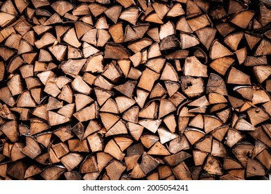 textured firewood background of chopped wood for kindling and heating the house. a woodpile with stacked firewood. the texture of the birch tree