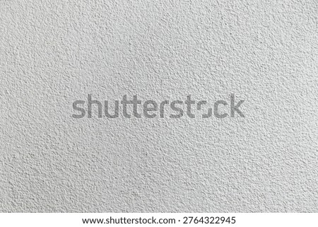 A textured grainy surface is shown with a light color. This surface can serve as a background for designs and projects. It offers a neutral appearance suitable for multiple uses.