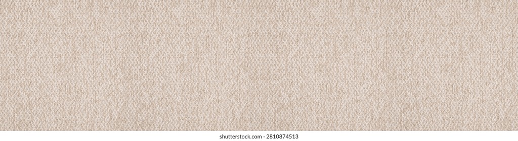 Textured high angle view of a soft beige boucle canvas fabric showcasing a nubby granular surface structure and cozy organic weave.