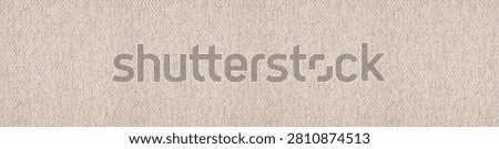 Textured high angle view of a soft beige boucle canvas fabric showcasing a nubby granular surface structure and cozy organic weave.