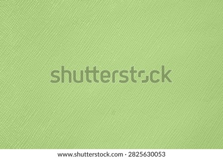 A textured, light green surface with a subtle crosshatch pattern.