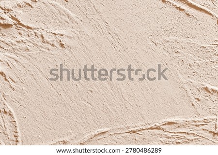Textured light tan plaster wall with diagonal trowel marks and ridges
