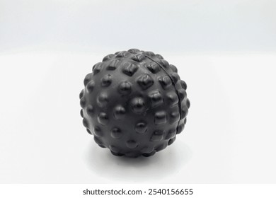 A textured massage ball designed for deep tissue relief and muscle relaxation, ideal for athletes and individuals seeking therapeutic pain relief, fitness, and wellness benefits - Powered by Shutterstock