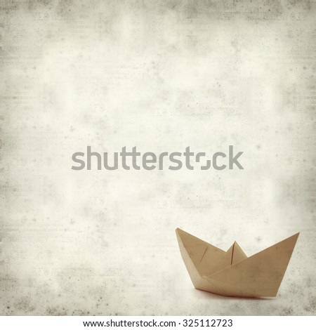 textured old paper background with origami paper boat