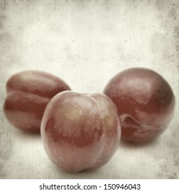 textured old paper background with red plums