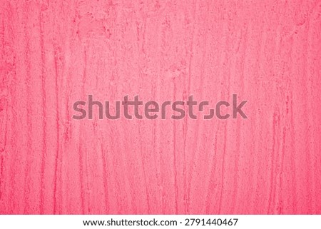 Textured pink plaster surface with vertical striations.