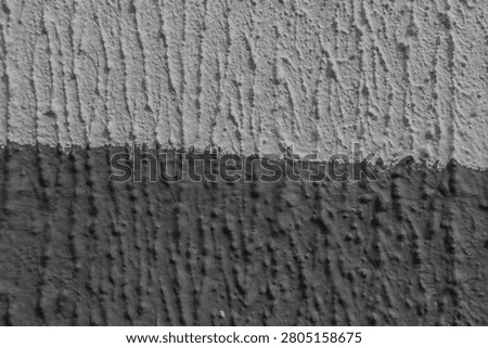 textured plaster wall surface background with contrast horizontal split. Abstract two-tone decorative stucco with bark beetle pattern, ideal for modern urban interior design, grungy building facades and architectural backdrops.