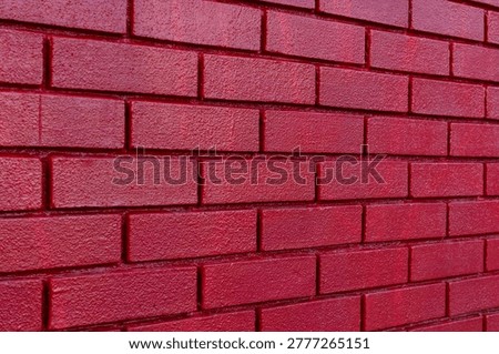 Textured red brickwork background surface. Close up texture of red painted brick wall