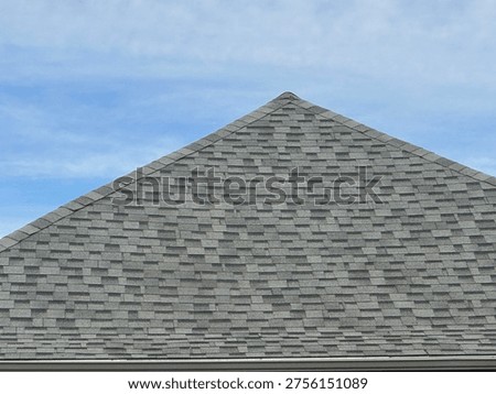 Textured roofing shingles pattern on suburban home roof