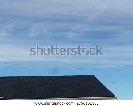 Textured roofing shingles pattern on suburban home roof