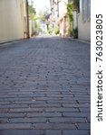 Textured, rough brick street leading to courtyard homes and shops in Saint Augustine, Florida