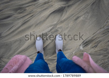 Textured sand with female feet