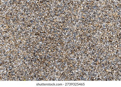 A textured surface composed of small, rounded stones, commonly identified as pea gravel