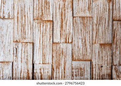 A textured wall background made of rustic white washed wooden bricks, showcasing a weathered surface with vertical brown grains and distressed design.