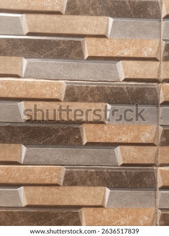 Textured wall tiles featuring a rustic stacked stone or brick look in varying shades of brown, grey, and beige. Ideal for modern rustic or natural interior design. #walltiles #texturedtiles #stackedst