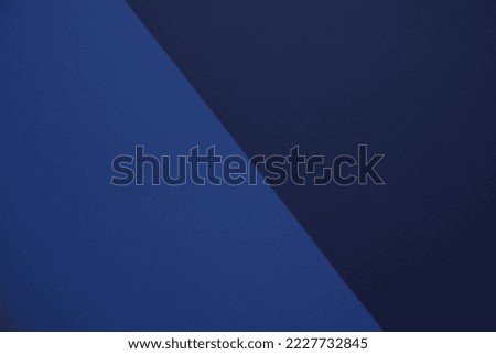Textured wallpaper in two shades of blue separated by diagonal line. Monochromatic color scheme. Bold, hip, minimalist, geometric, and modern background, mockup, and copy space for horizontal layout.