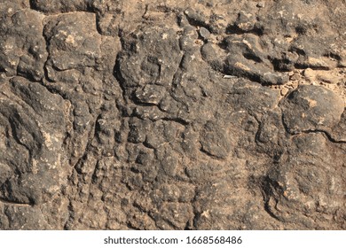 textures and patterns showing the formation of stone from ancient cooled lava flow on rock faces in a volcanic area rural Victoria, Australia.
