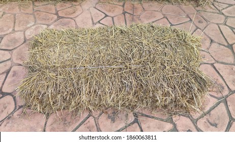Textures and patterns of tiled floors with brown straws placed close to each other.