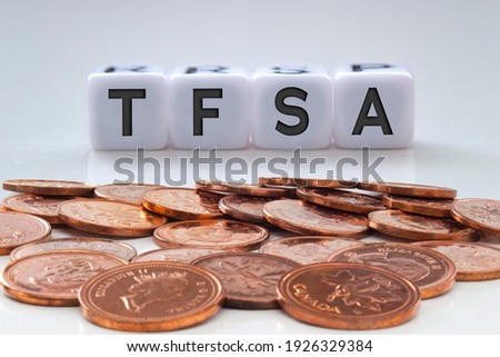 TFSA letters on white blocks with coins on a clear background